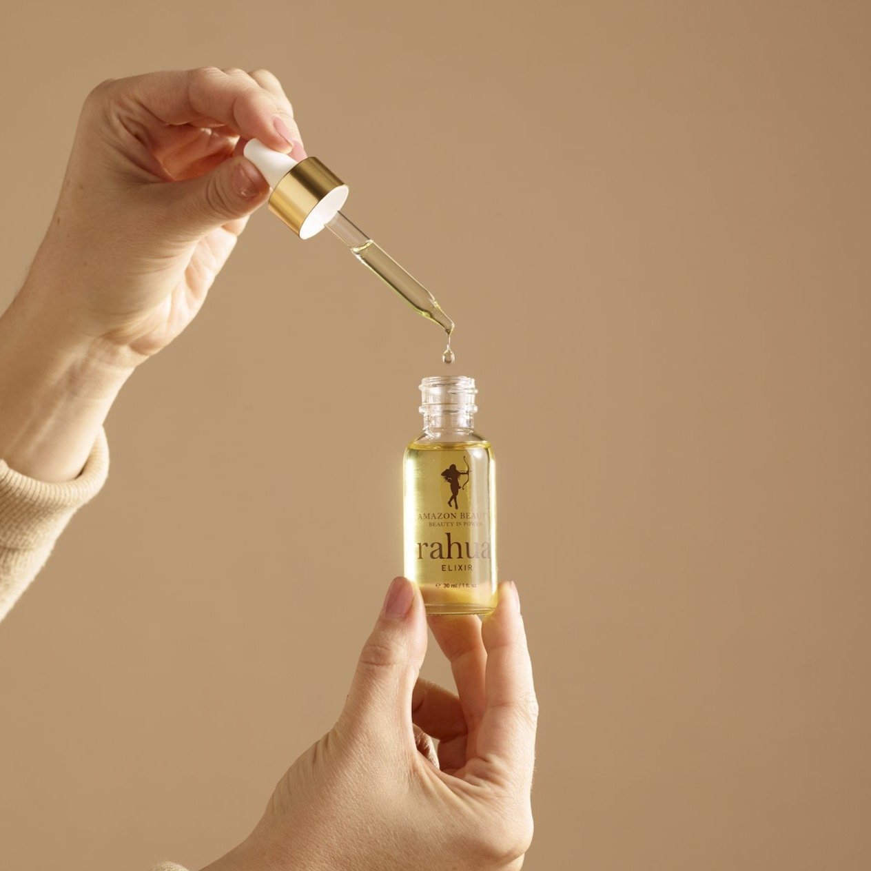 Woman Showing How to Take Elixir from the Elixir Bottle with its Dropper