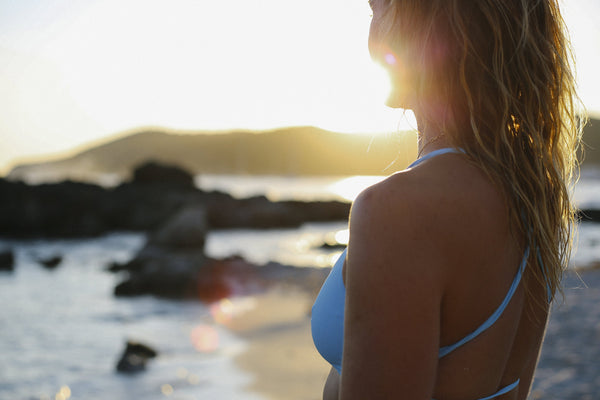 Women experiencing sun rise on the beach