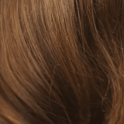 Woman showing silky hair after using Rahua Heat Protectant Shield