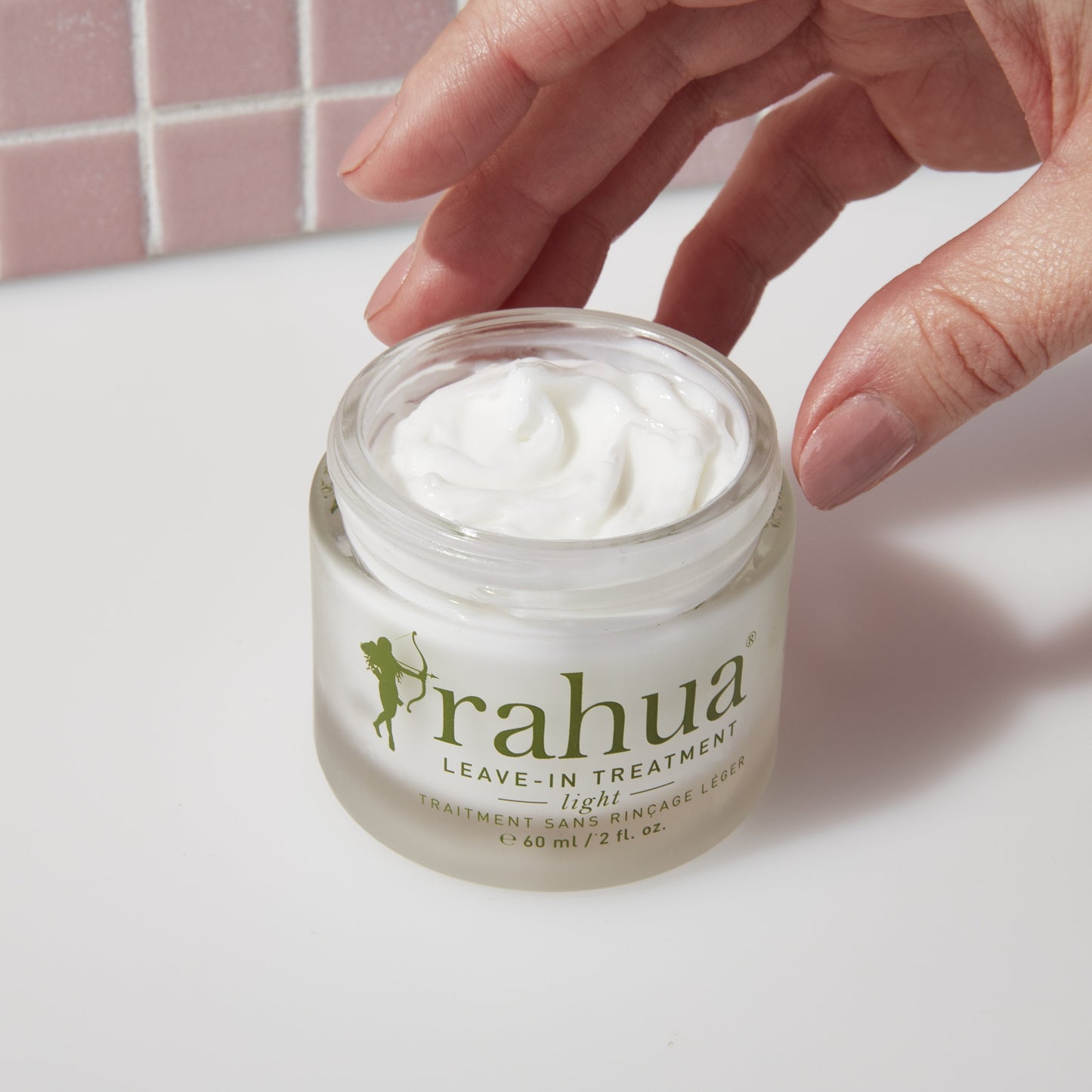 leave in treatment light with its creamy texture spread in the background