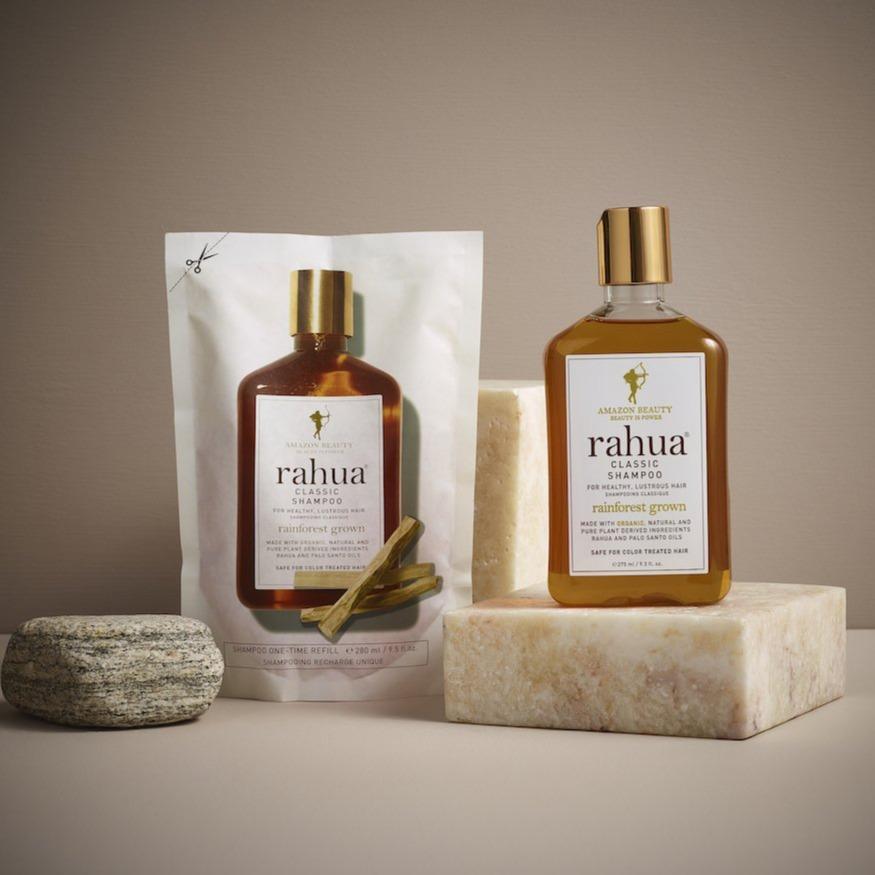 rahua classic shampoo refill pouch with rahua classic shampoo bottle placed on a marble block