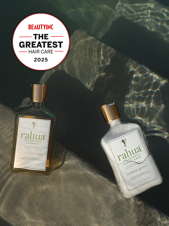 two bottles of plastic with gold caps of rahua voluminous shampoo and voluminous conditioner floating on the surface of a pool on top of concrete stairs with a sticker in the top left of beauty inc the greatest hair care 2025|variant:2-oz